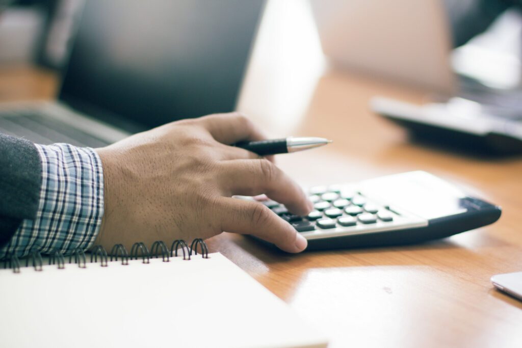 Businessman,Working,On,Desk,Office,With,Using,A,Calculator,To