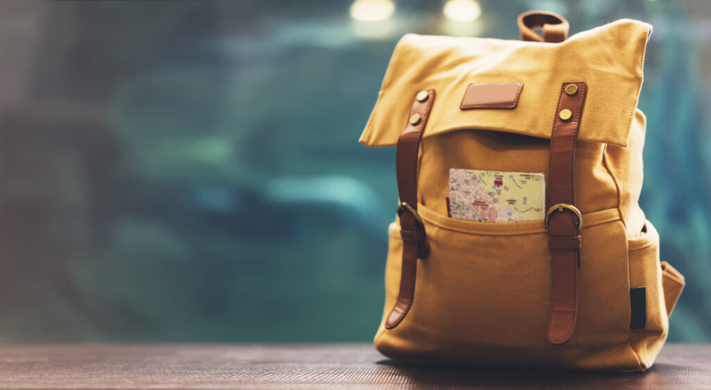 Hipster,Yellow,Backpack,And,Map,Closeup.,View,From,Front,Tourist